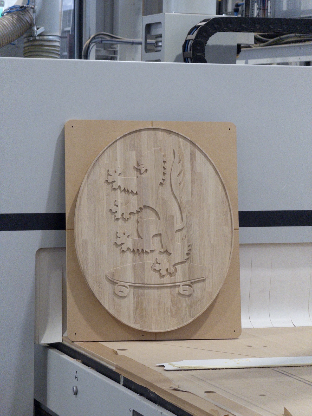 Heraldic crest carved in 3D relief into laminated oak
